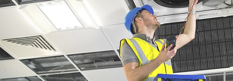 man repairing AC